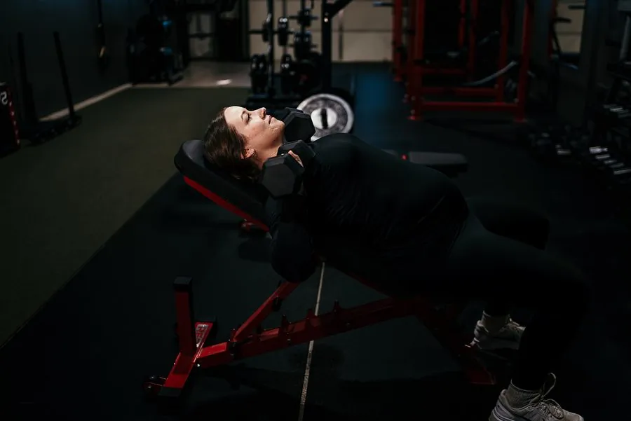Client doing an incline dumbbell press at Anew Training